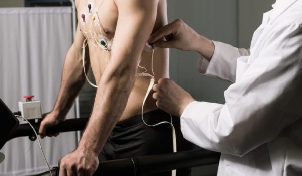 Athletic man with cardiogram electrodes